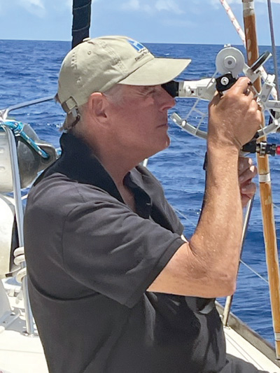 man practicing celestial navigation while sailing